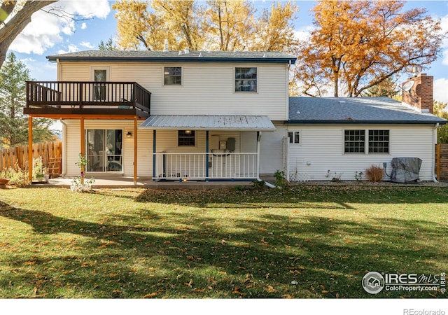 rear view of property with a yard