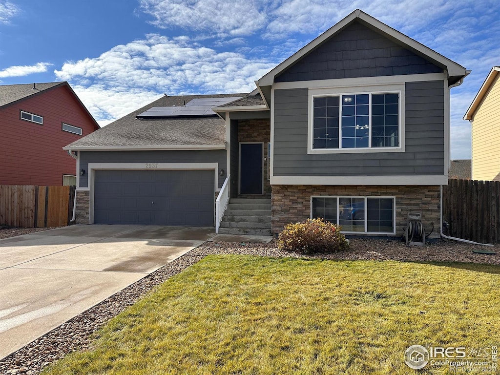 view of front of house with a garage and a front yard