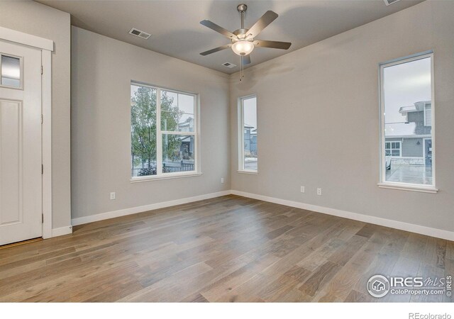 empty room with light hardwood / wood-style floors and ceiling fan