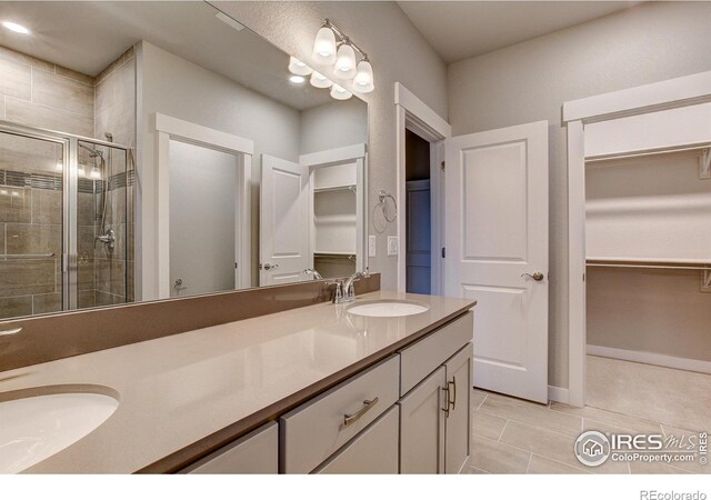 bathroom featuring vanity, tile patterned floors, and a shower with door