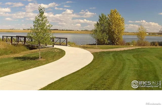 view of community with a water view and a lawn