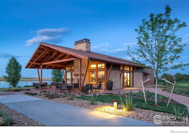 exterior space featuring a patio and a water view