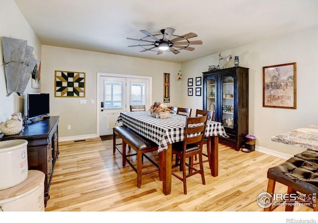 dining room featuring light hardwood / wood-style floors and ceiling fan