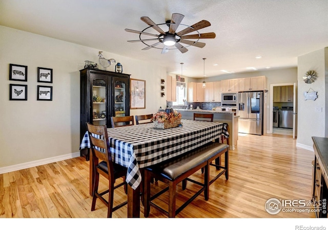 dining area with light hardwood / wood-style floors and ceiling fan