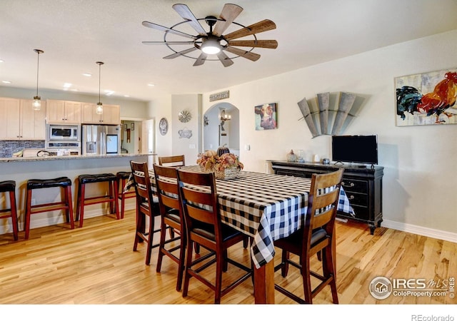 dining room with light wood-type flooring and ceiling fan