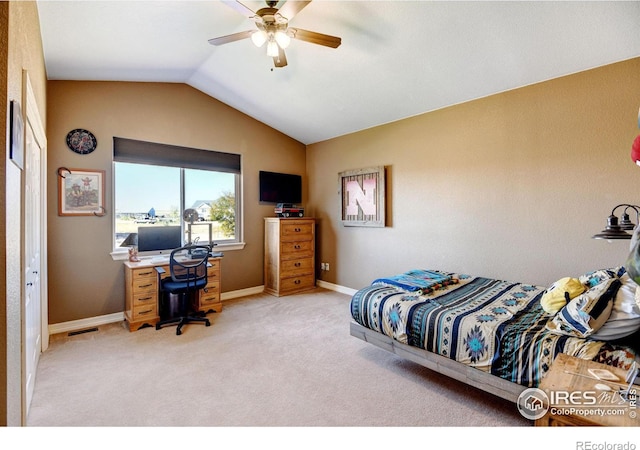 bedroom with ceiling fan, vaulted ceiling, and light colored carpet