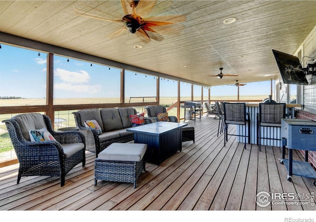 wooden deck with ceiling fan and an outdoor hangout area