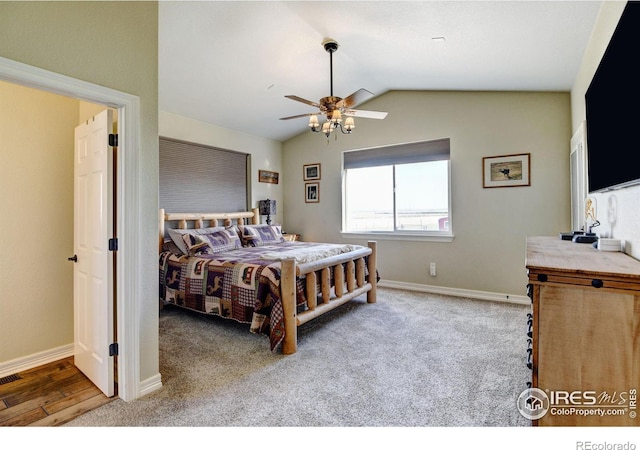 bedroom featuring light hardwood / wood-style floors, lofted ceiling, and ceiling fan