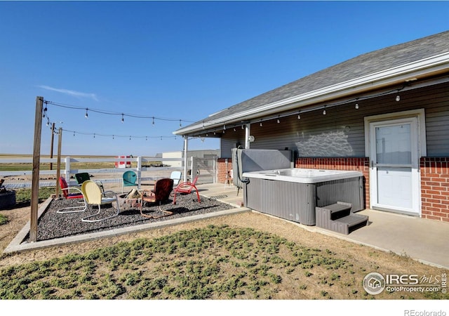 view of yard with a hot tub and a patio area