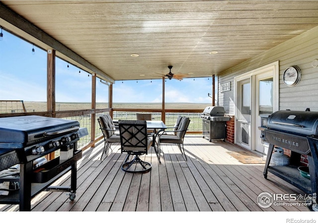 deck with grilling area and ceiling fan