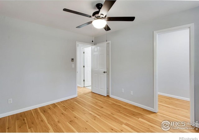 empty room with ceiling fan and light hardwood / wood-style flooring