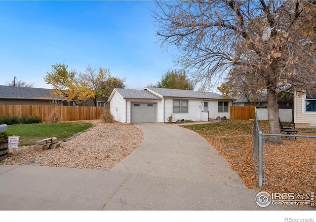 ranch-style house featuring a garage and a front yard