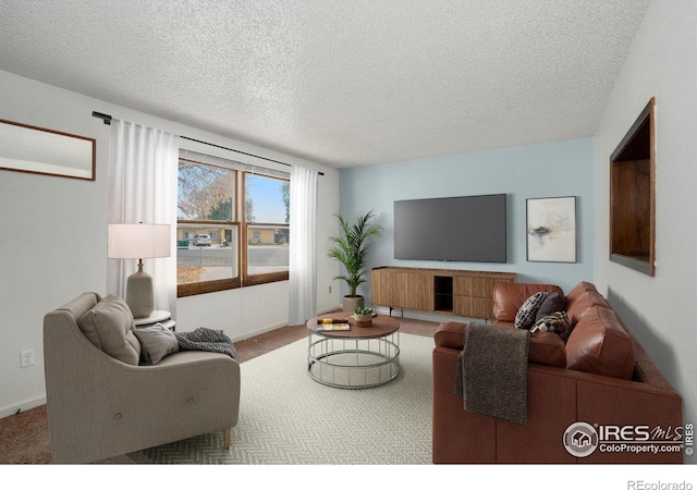 carpeted living room featuring a textured ceiling