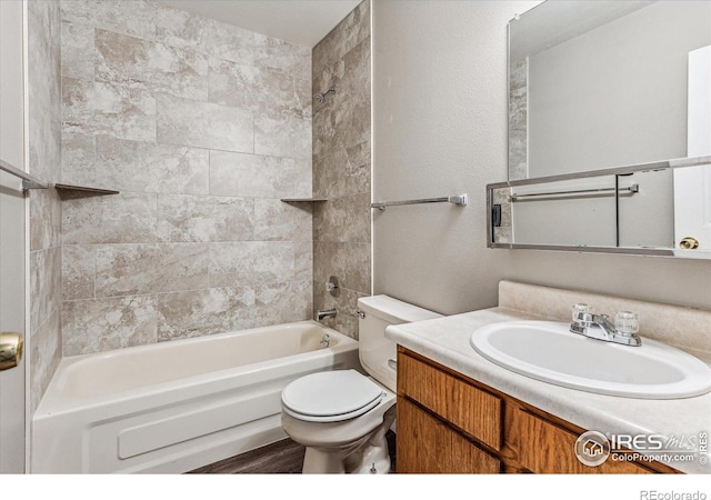 full bathroom featuring vanity, toilet, and tiled shower / bath combo