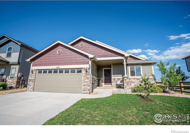 craftsman-style house featuring a garage and a front lawn