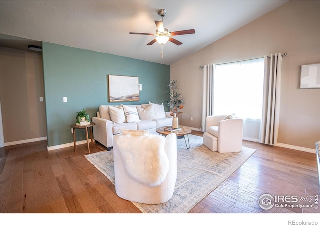 living room featuring wood-type flooring, vaulted ceiling, and ceiling fan