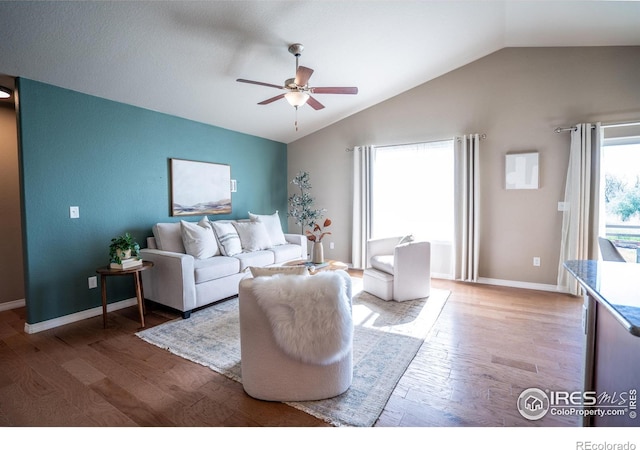 living room featuring lofted ceiling, hardwood / wood-style floors, and ceiling fan