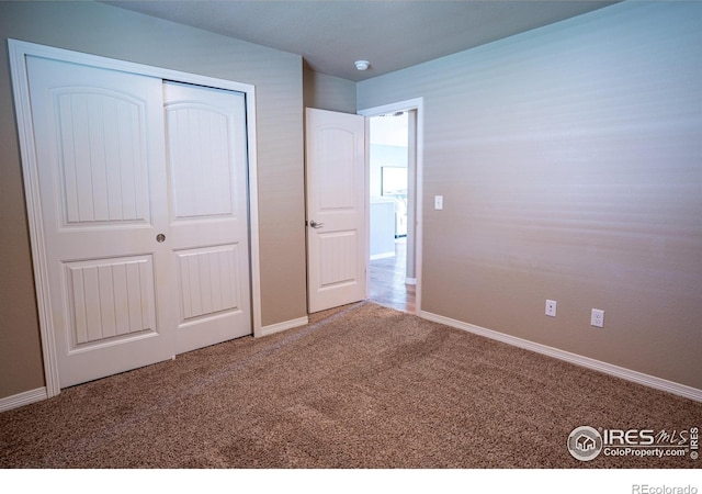 unfurnished bedroom with a closet and carpet