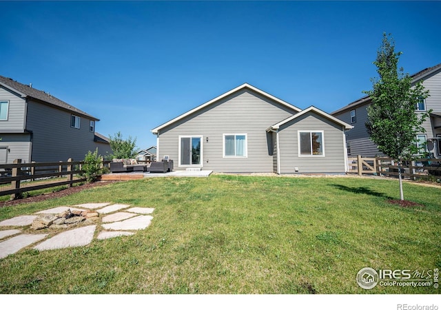 back of property featuring a patio and a lawn