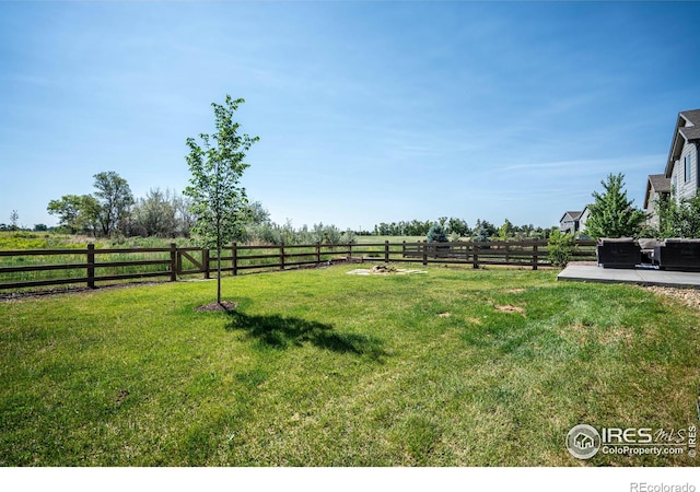 view of yard featuring a rural view and a patio area