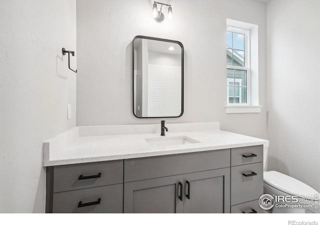 bathroom featuring vanity and toilet