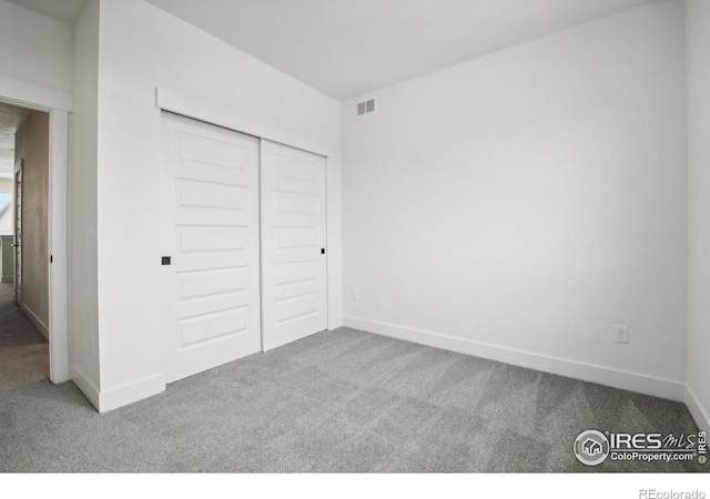 unfurnished bedroom featuring a closet and carpet