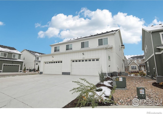 view of property with a garage and central AC