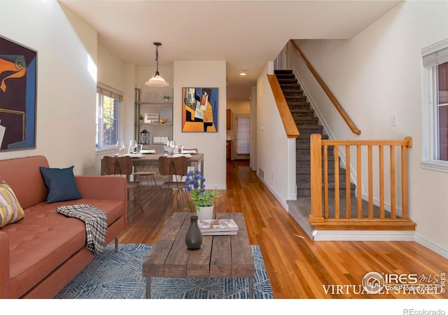 818 S Terry St Unit 85, Longmont, CO 80501 - living area with wood finished floors, stairway, and baseboards