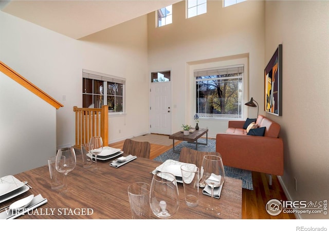 818 S Terry St Unit 85, Longmont, CO 80501 - dining area with a towering ceiling, wood finished floors, and baseboards