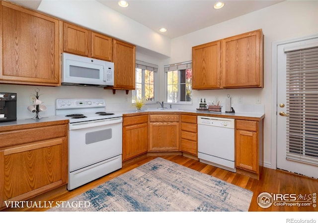 818 S Terry St Unit 85, Longmont, CO 80501 - kitchen with white appliances, light wood-type flooring, a sink, recessed lighting, and light countertops
