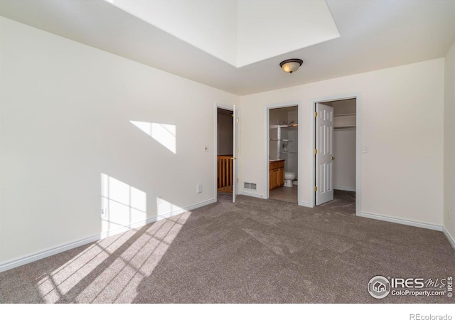 818 S Terry St Unit 85, Longmont, CO 80501 - unfurnished bedroom featuring carpet floors, baseboards, a spacious closet, and ensuite bathroom