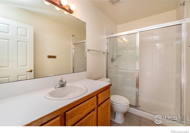 bathroom with walk in shower, tile patterned flooring, vanity, and toilet