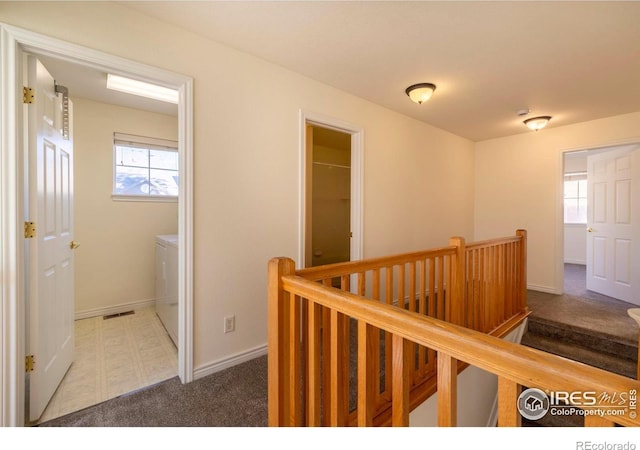818 S Terry St Unit 85, Longmont, CO 80501 - hallway featuring an upstairs landing, separate washer and dryer, plenty of natural light, and carpet floors