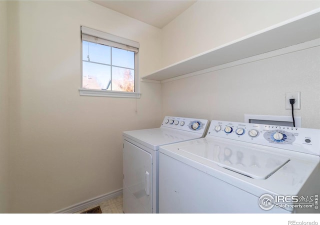 clothes washing area with independent washer and dryer