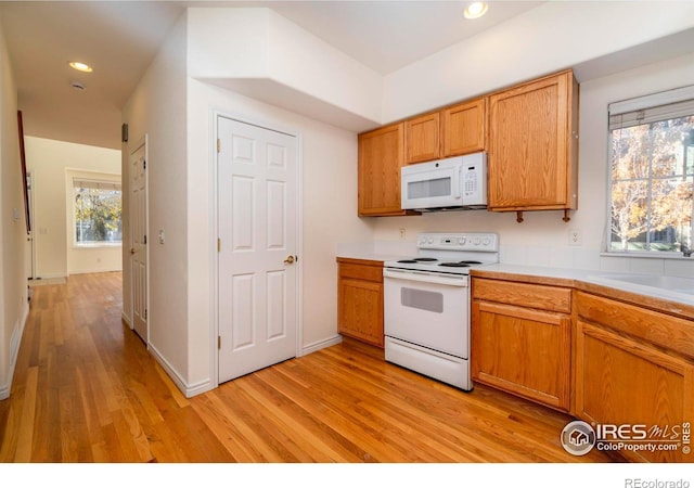 818 S Terry St Unit 85, Longmont, CO 80501 - kitchen featuring white appliances, light wood-type flooring, light countertops, recessed lighting, and brown cabinets