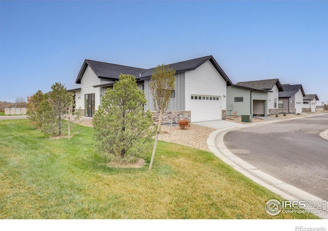 view of front facade with a garage and a front lawn