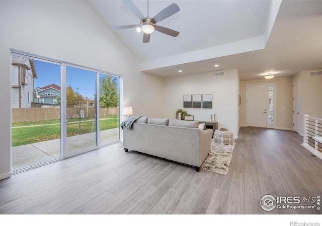 living room with high vaulted ceiling, light hardwood / wood-style floors, and ceiling fan