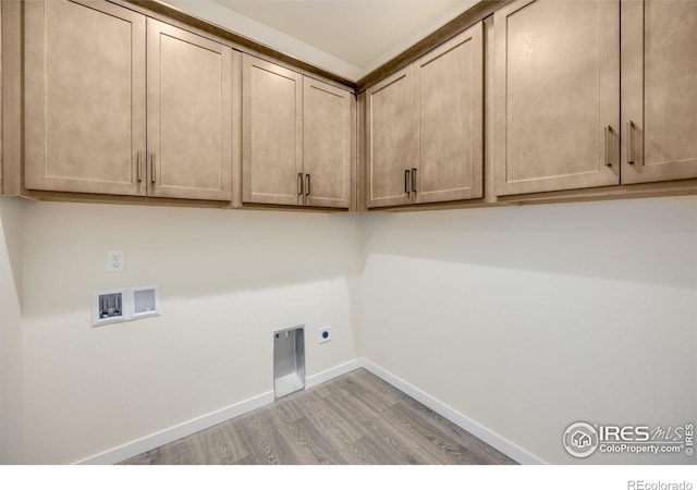 laundry room with hookup for an electric dryer, light wood-type flooring, washer hookup, and cabinets