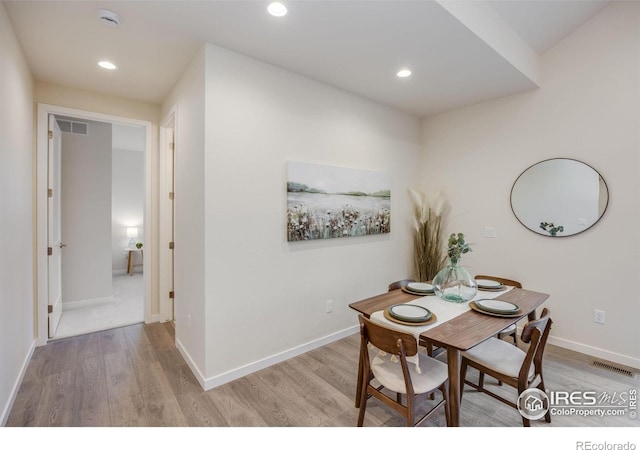 dining area featuring light wood-type flooring