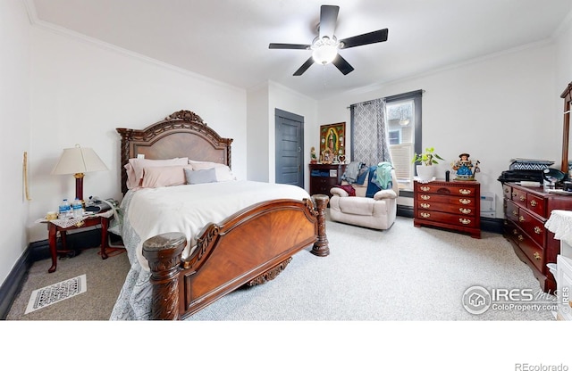 carpeted bedroom featuring crown molding, ceiling fan, and a closet