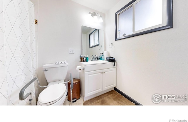 bathroom featuring vanity, tile patterned floors, and toilet