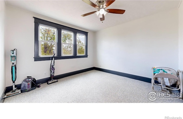 interior space featuring ceiling fan and carpet