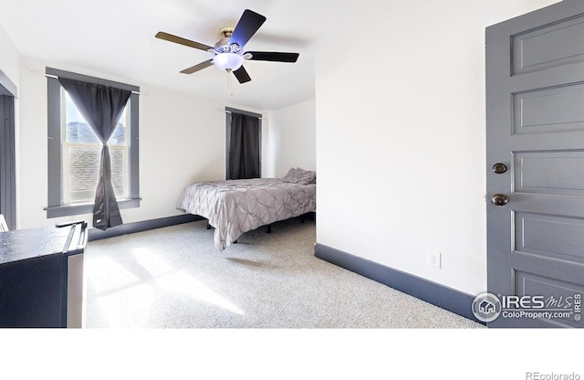 carpeted bedroom with ceiling fan