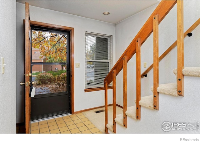 doorway with tile patterned flooring