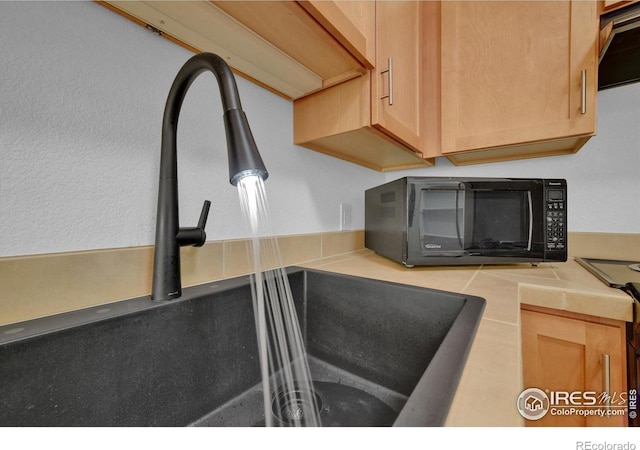 details featuring exhaust hood and sink