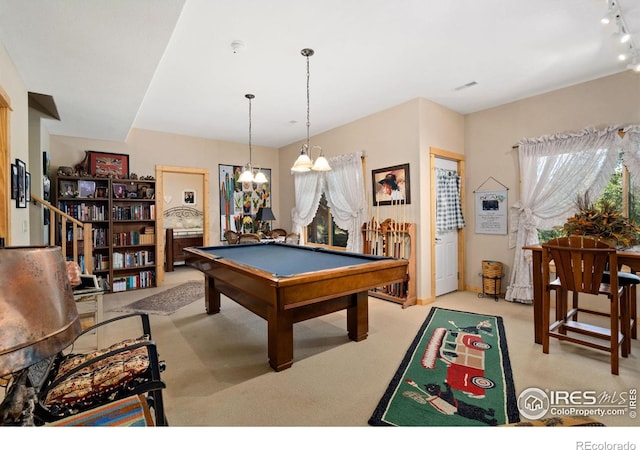 recreation room featuring a chandelier, rail lighting, light carpet, and billiards