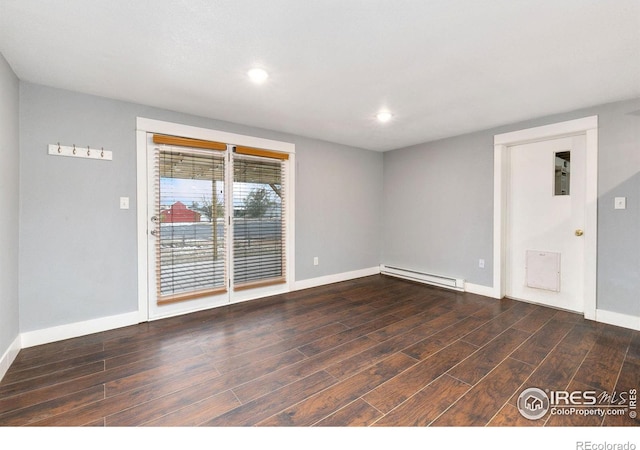 empty room with dark wood-type flooring, a baseboard radiator, and baseboards