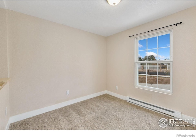 spare room featuring carpet floors, baseboards, and baseboard heating