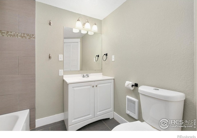 full bathroom with visible vents, toilet, vanity, a tub, and baseboards