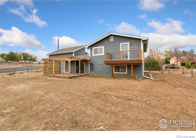 back of house featuring fence private yard and a deck